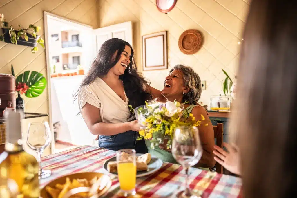 Family enjoying quality time while a respite caregiver supports a loved one